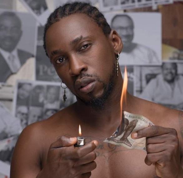 Orezi causes outrage on social media after burning Nigerian currency in new photo 27