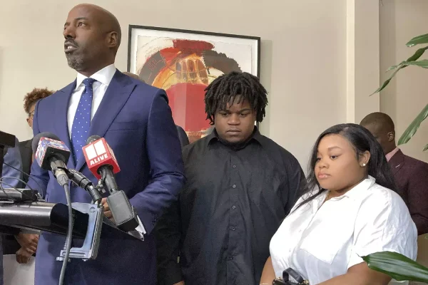 Attorney Cory Lynch, left, joined by Treveon Isaiah Taylor, Sr., Jessica Ross, speaks during a news conference, Wednesday, Aug. 9, 2023, in Atlanta, announcing a lawsuit against a doctor and Southern Regional Medical Center, a hospital south of Atlanta where Ross went on July 9 to have her son. SUDHIN THANAWALA/AP PHOTO